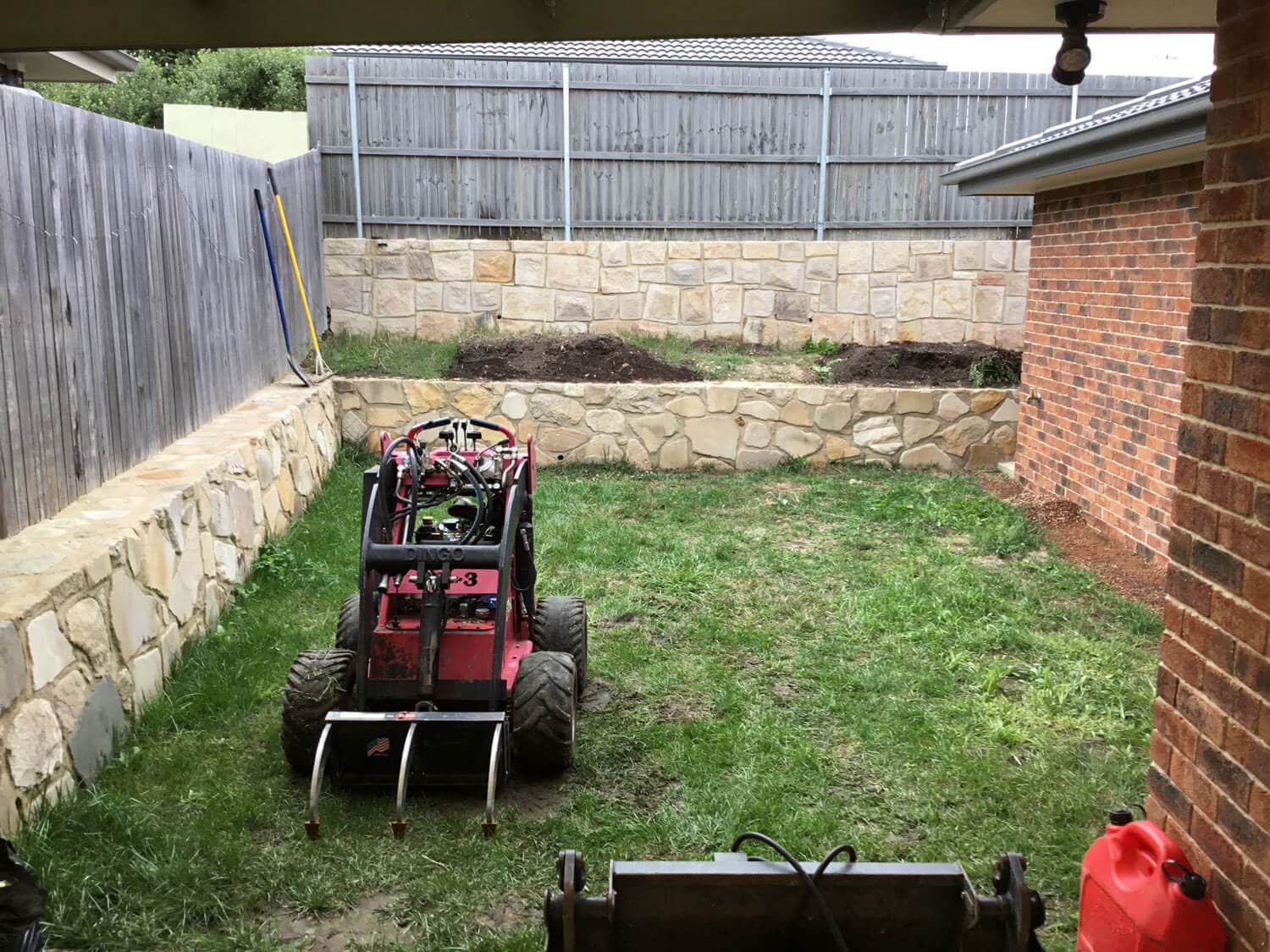 Gardengigs-Bonner-Before-Landscaping-View-of-the-Back-Garden-with-Tilling-Machine