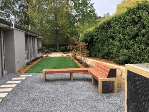 Gardengigs Residential Works - Full View of the Garden with Wooden Benches and Bush Tree Fencing